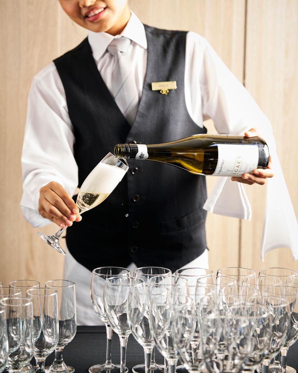 Sofitel Melbourne On Collins Hotel Eksteriør billede A sommelier pouring champagne